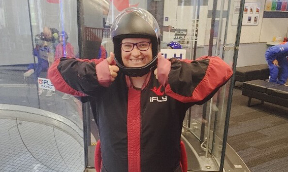 person wearing helmet giving thumbs up